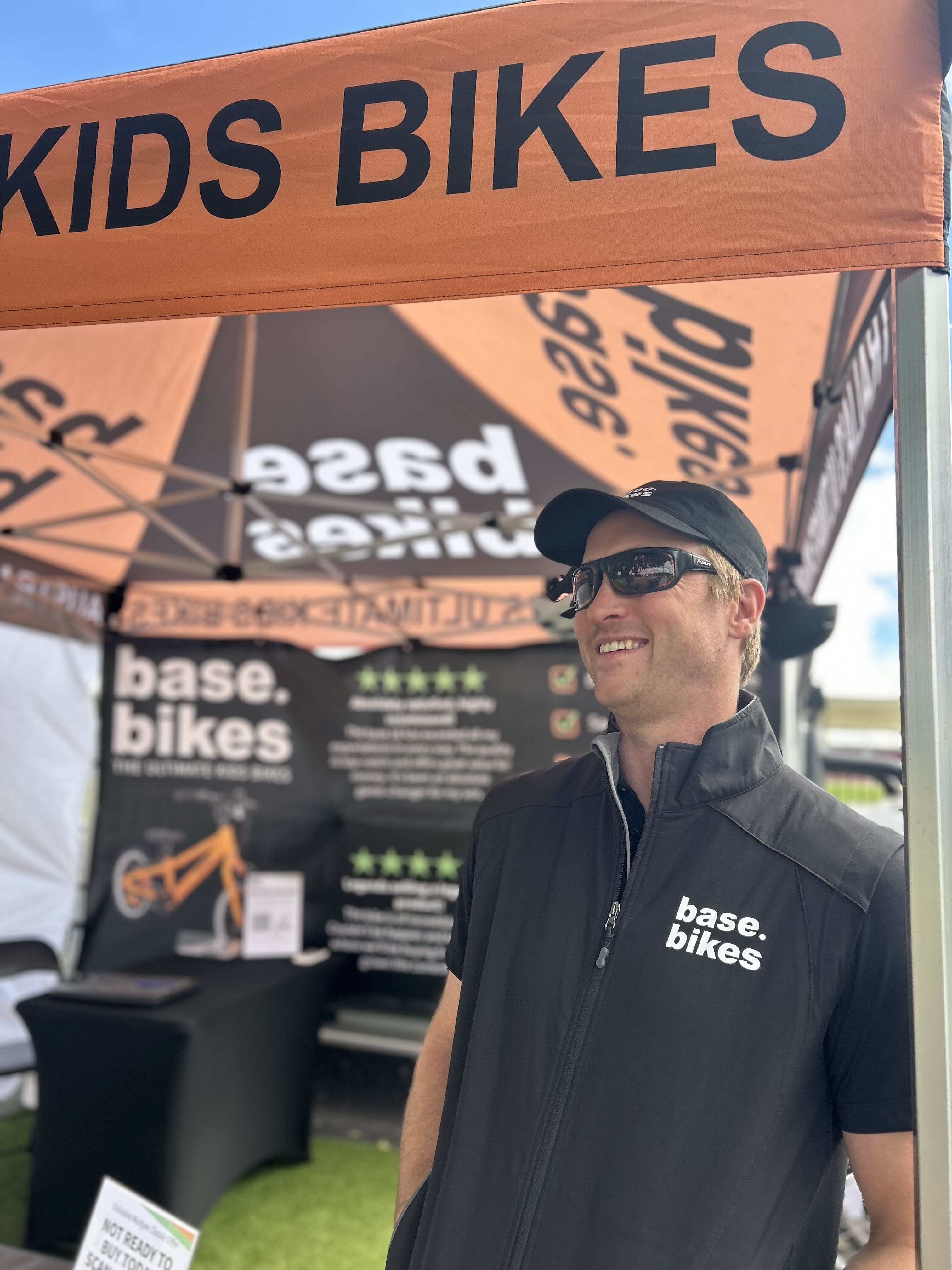 base bikes founder smiling at the front of his event stand