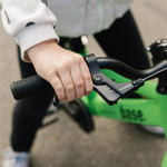 Close up of kids hand easily reaching the brake lever on the base 16
