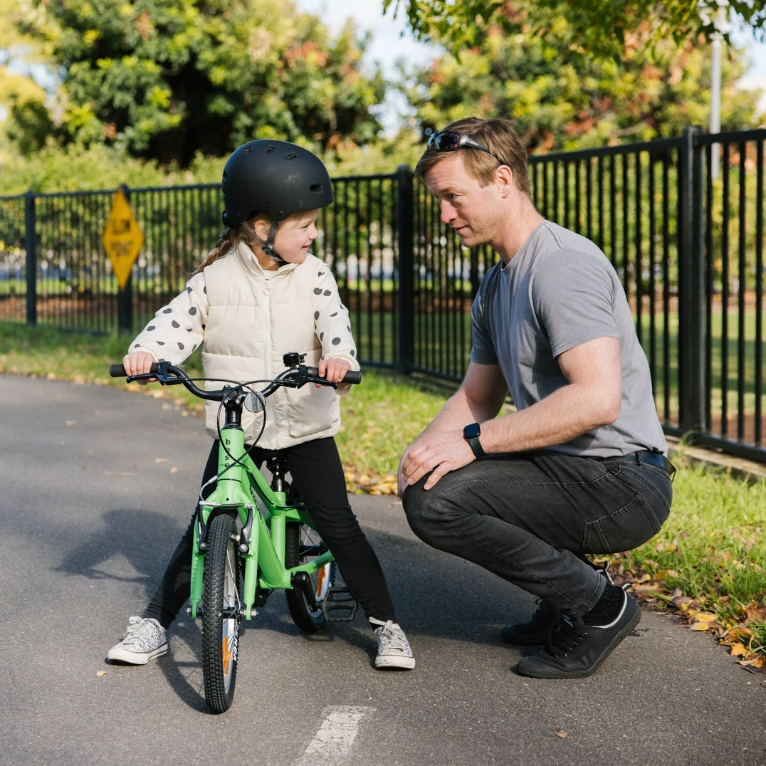 Dad chatting to five year old girl on her 16 inch bike