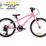 A pink children's bicycle with black tires, black saddle, and black handlebars, shown in a side profile on a white background. A brand badge for 'base' is visible on the frame, and a review graphic for 'Two Wheeling Tots' is in the top-left corner.