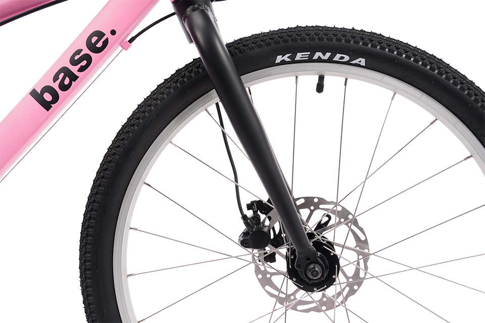 Close-up of a pink bicycle wheel with 'base' branding and Kenda tire.