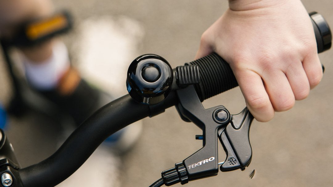 Close up of kiddies hand pulling on Tektro brake lever