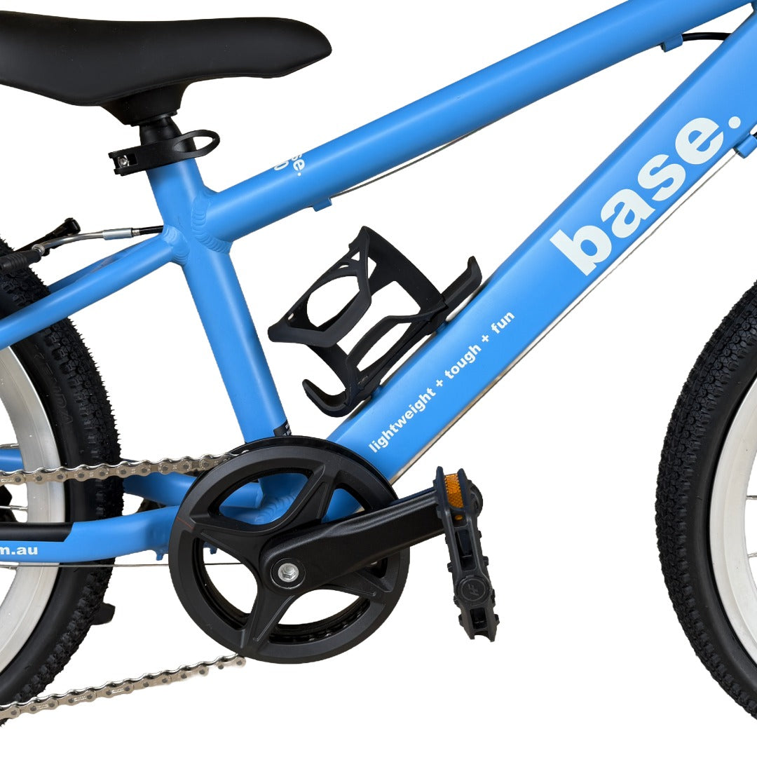 Close-up of a white water bottle with a black cap mounted in a black frame-mounted bottle holder on a bright blue bicycle frame.