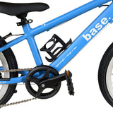 Close-up of a white water bottle with a black cap mounted in a black frame-mounted bottle holder on a bright blue bicycle frame.