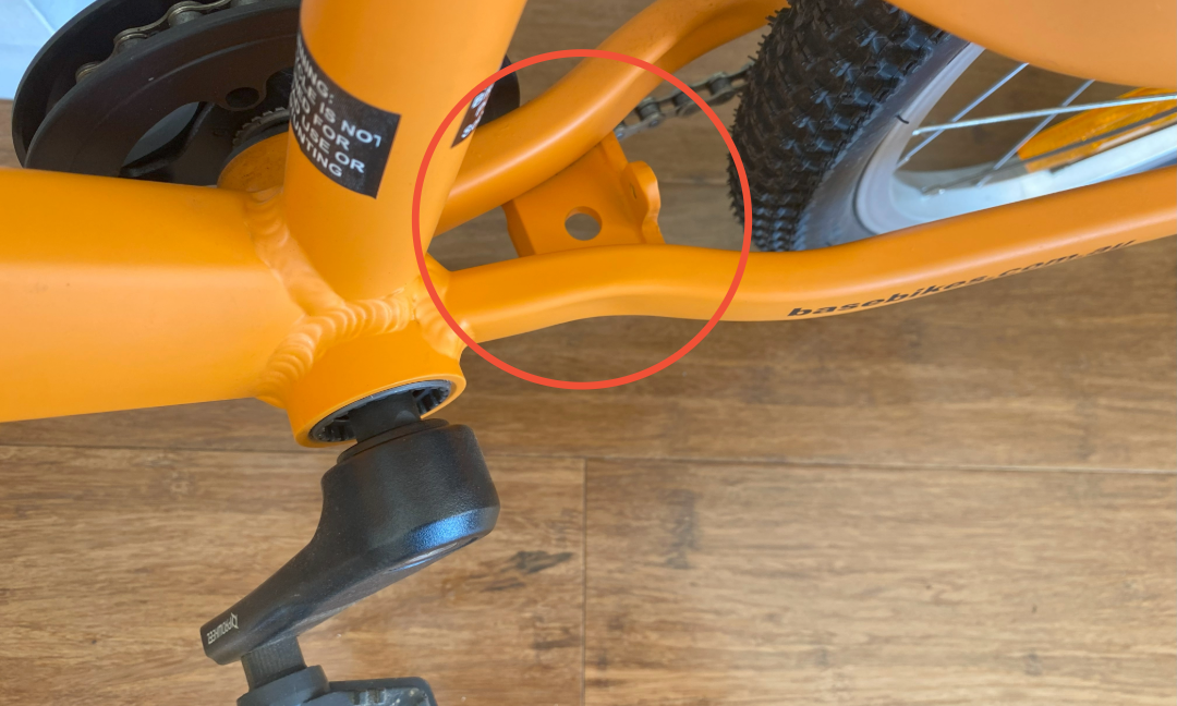 Circled location on a 16 inch kids bike to show where the kick stand is mounted